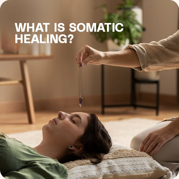 Alt text: "A woman lying down with another person holding a pendulum above her, in a calm indoor setting.